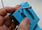Insert a servo stopper and secure with 1.5" screws