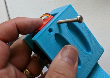 Use the servo stopper and two screws to lock the servo in place